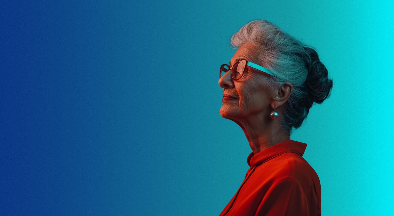 Older woman in red against a blue and teal background
